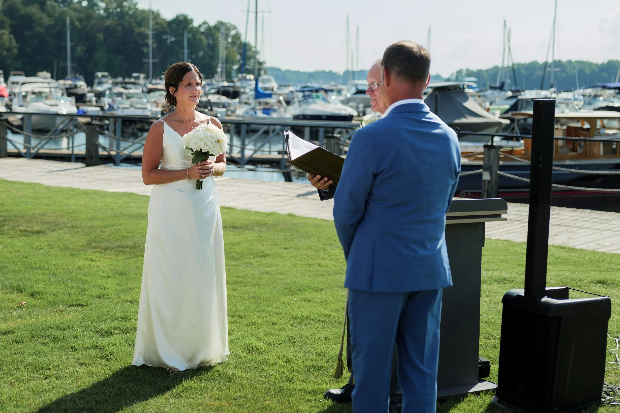 bride and groom during ceremony at Safe Harbor Peninsula by Charlotte wedding photographer Brandon Pickett Photography