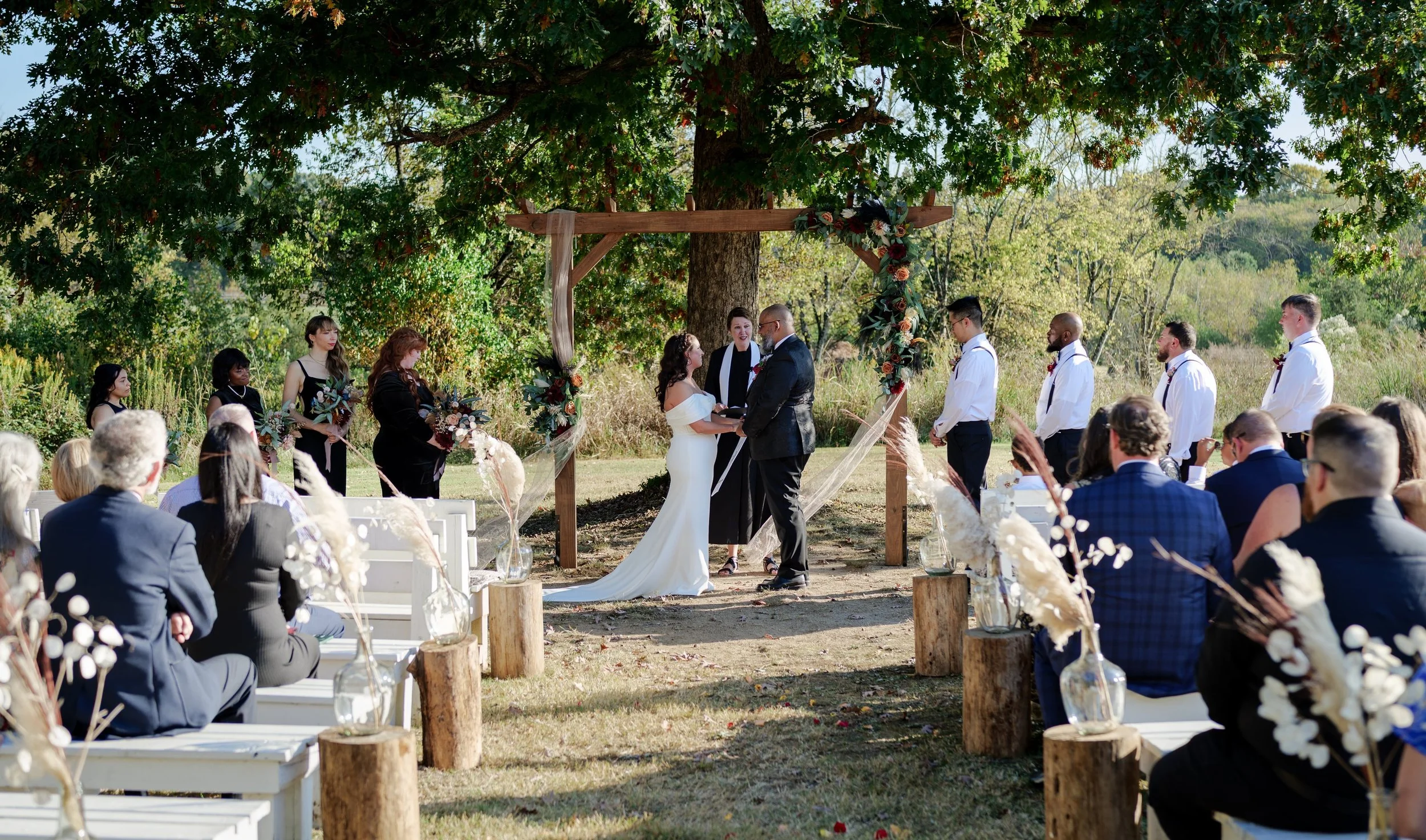 Bride and Groom with seated guests during wedding ceremony at The !932 Barn wedding venue in Charlotte, NC