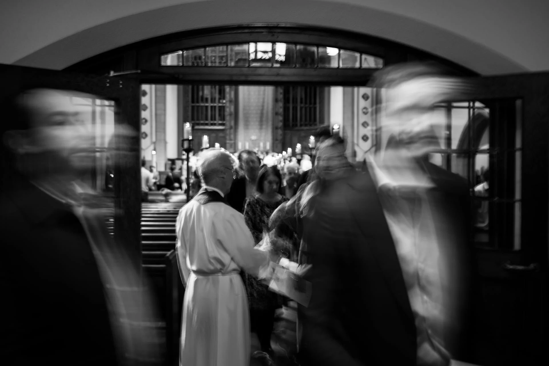 Myers Park United Methodist Church 100 year anniversary event. Blurry black and white photo with priest in focus.