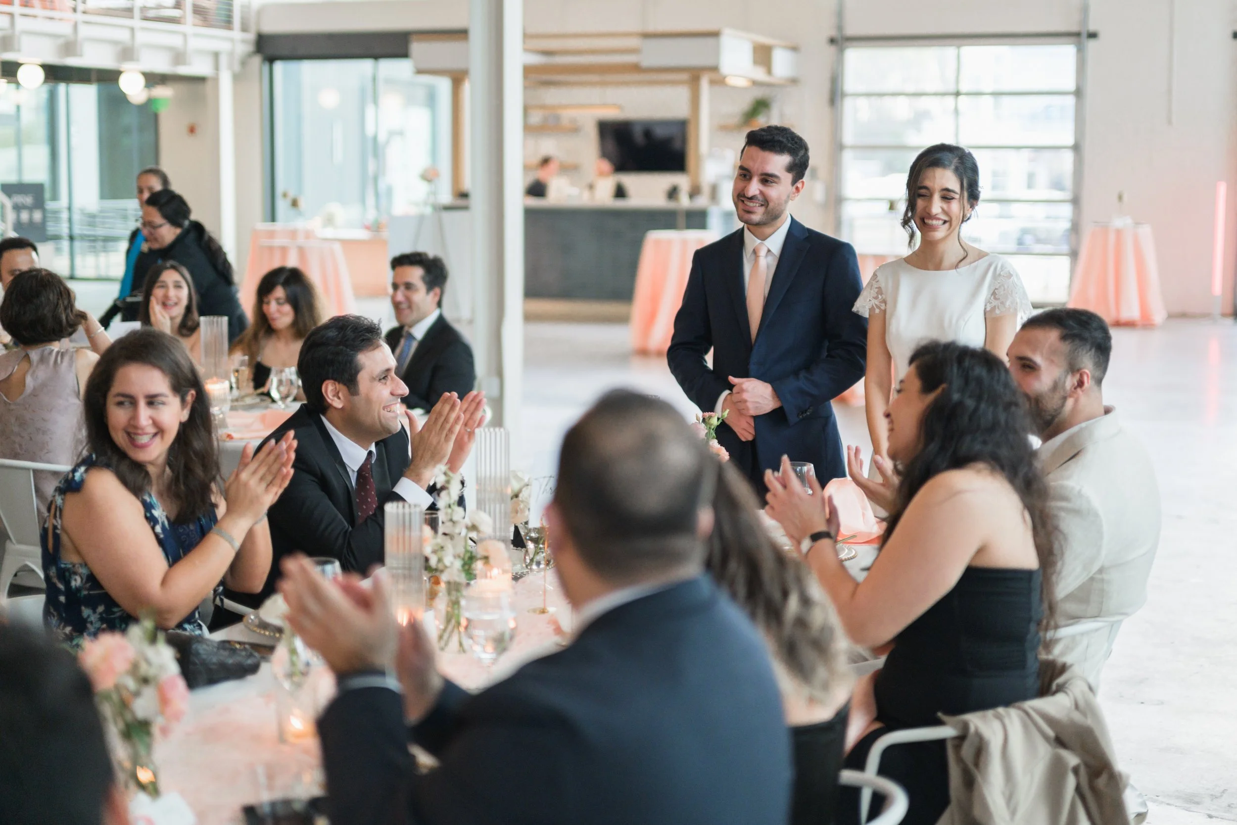 Guests cheering during toasts at PINE engagement party in Charlotte