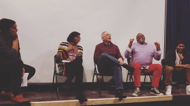  Our Black History Month movie screening and panel discussion “In Vibrant Color” was the last time we met in person, just over 2 weeks before the awareness of COVID really hit us.     5 people sitting on chairs on a stage. A movie projector screen co
