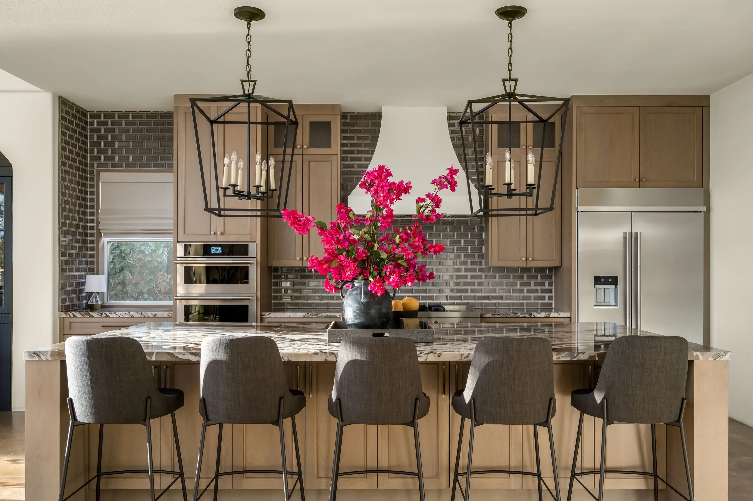 Rancho Pointe kitchen in Rancho La Quinta with quartzite island, custom cabinetry, tile backsplash, and pendant lighting