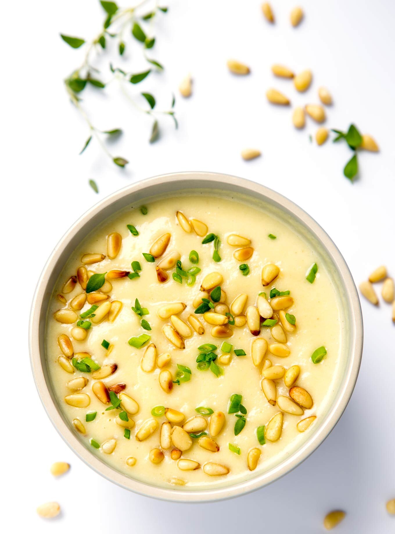 Celeriac soup with roasted garlic, chives and pine nuts