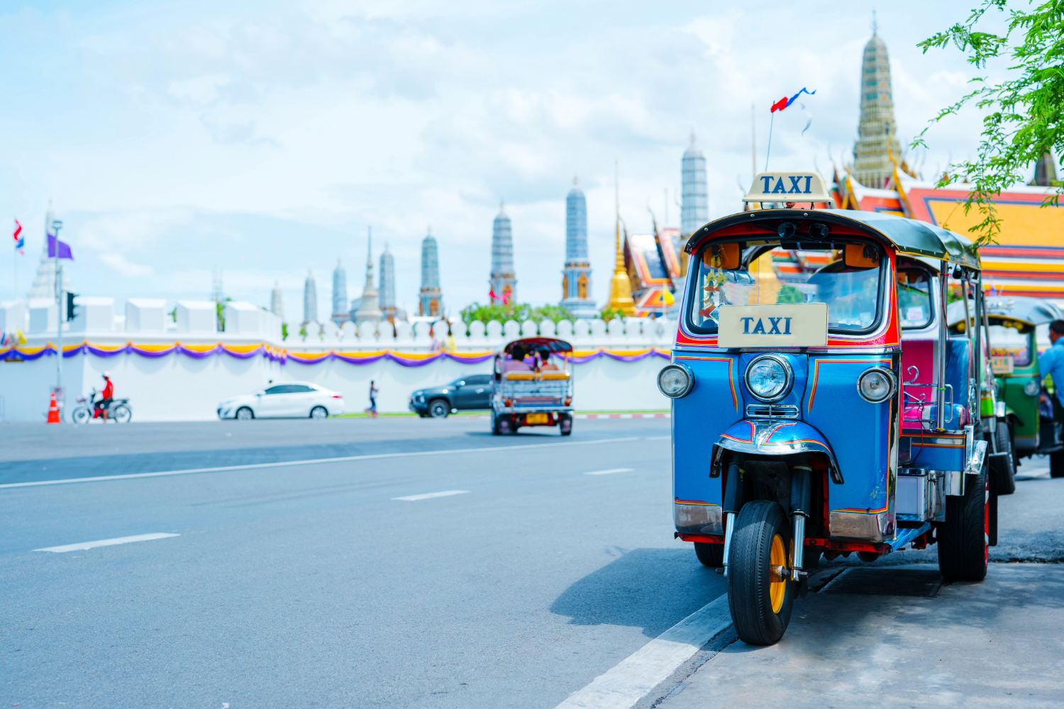 Local tuk tuk taxi in front of scenic landscape of the city in Bangkok