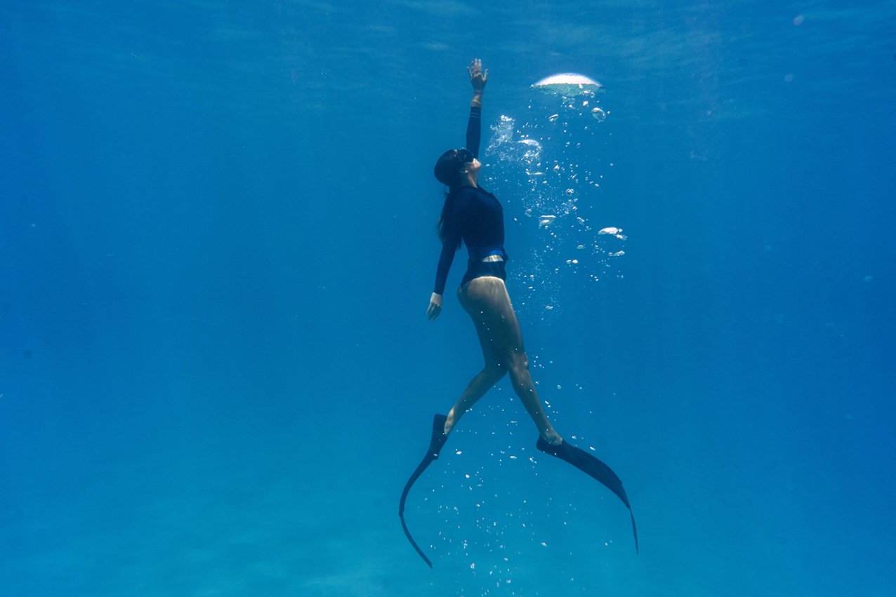 woman-freediving-with-flippers-underwater.jpeg