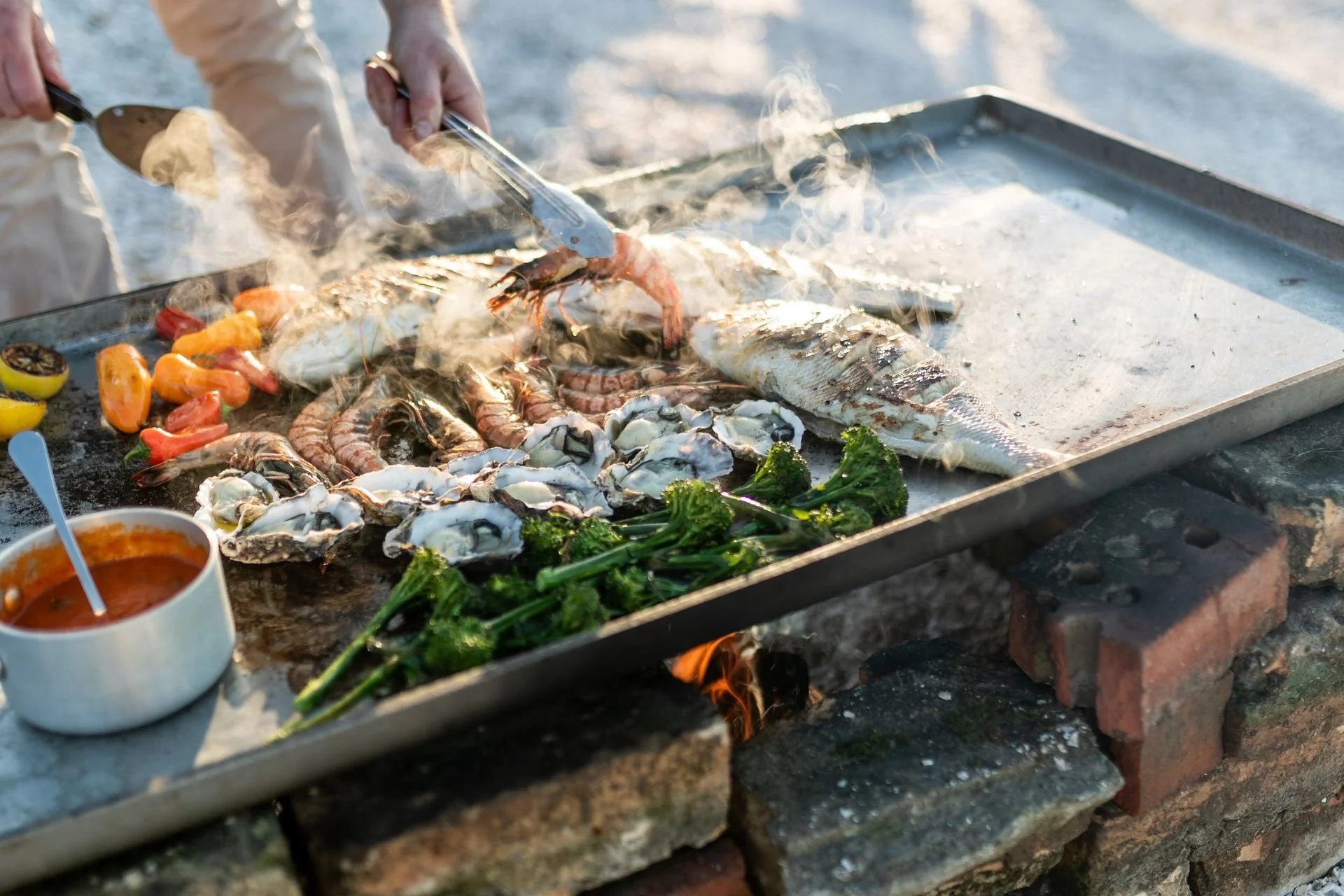 128157-close-up-of-chef-preparing-meal-on-beach-web-optimised-1920.jpg