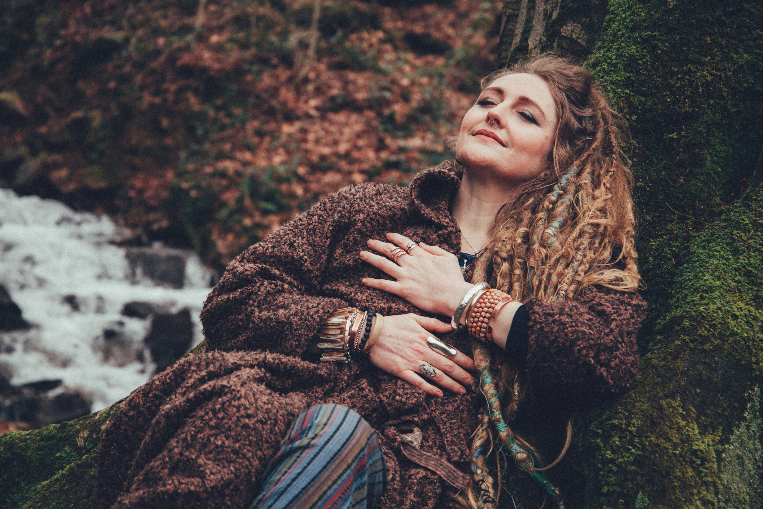 Woman with dreadlocks grounding at the base of a tree. Photographed in Blaen Bran Cwmbran
