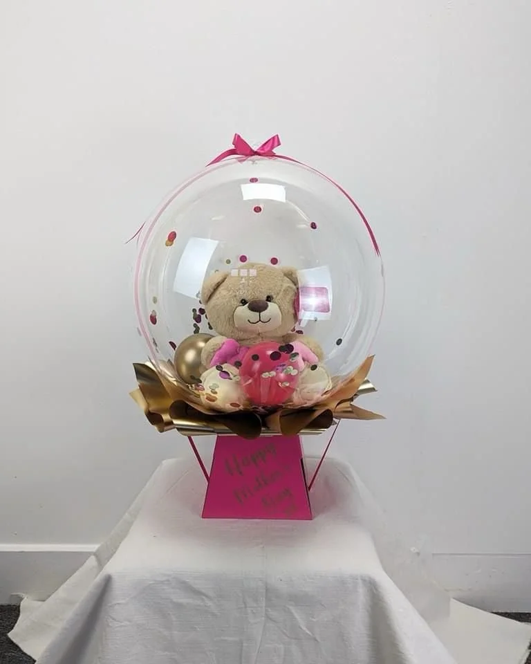 Teddy in Clearz balloon with trim on flower box £25 + bear