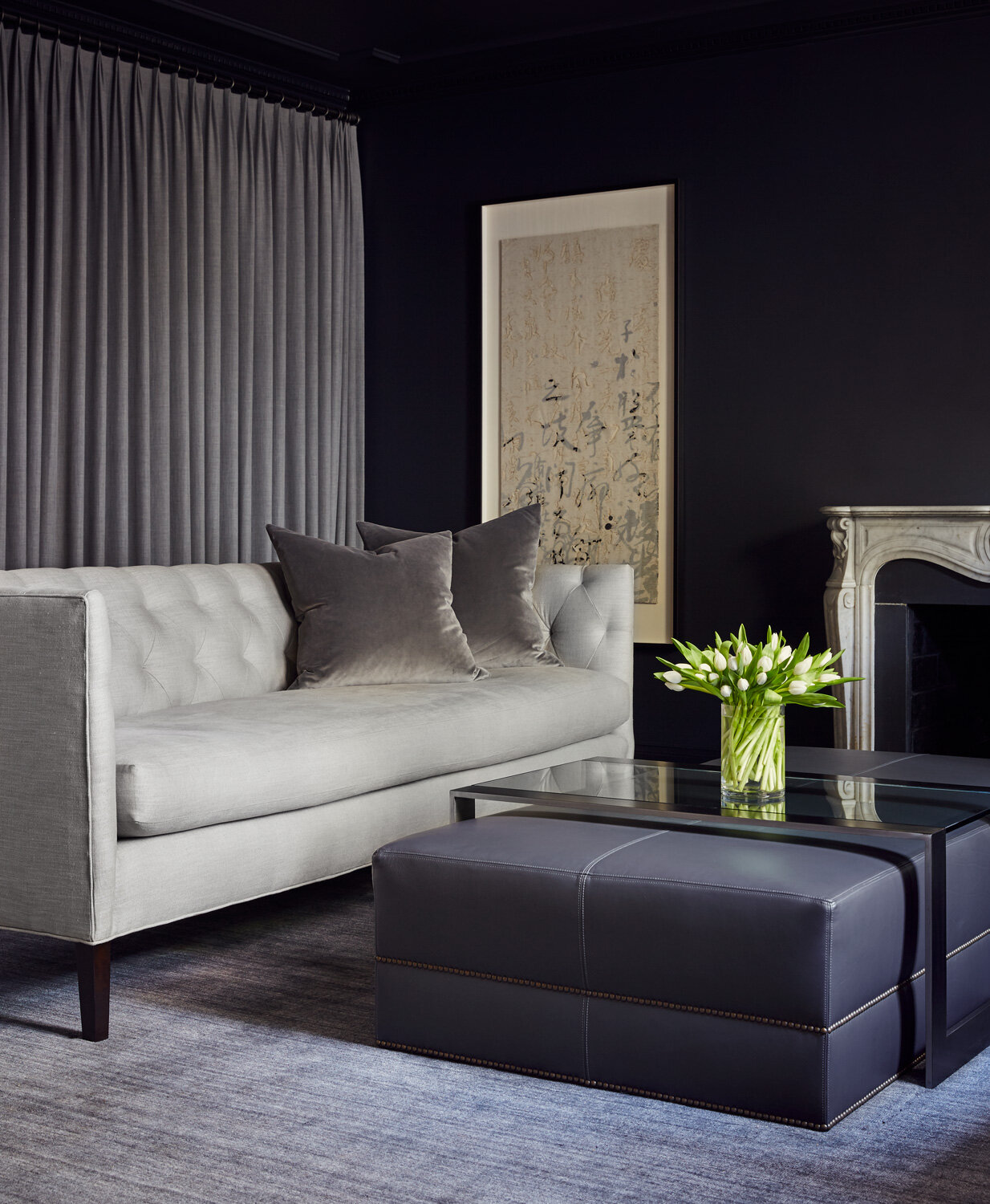 A townhome Living Room with deep blue-black walls to create a sophisticated entertaining space // Charlotte, NC