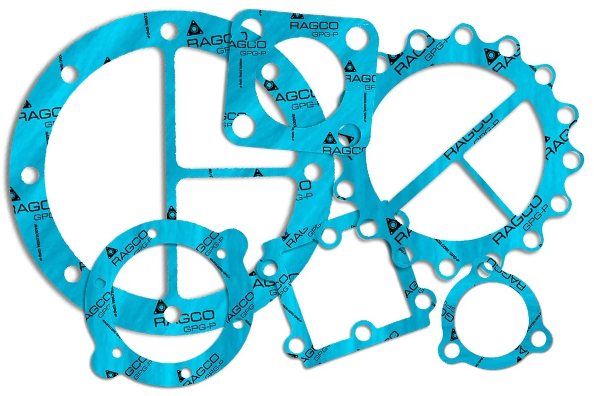 Various blue engine gaskets with RAGCO branding and different shapes and sizes.