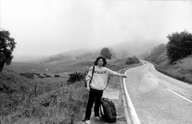 Julia Dean hitchhikes in Scotland in 1984.