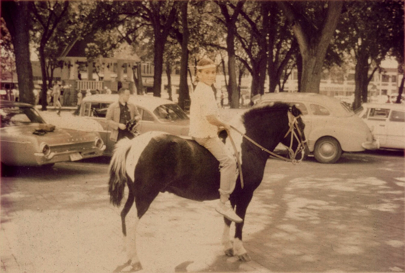 Julia Dean poses on her horse Spotty during a parade in which she took part in her hometown of Broken Bow, Nebraska. Circa 1964.
