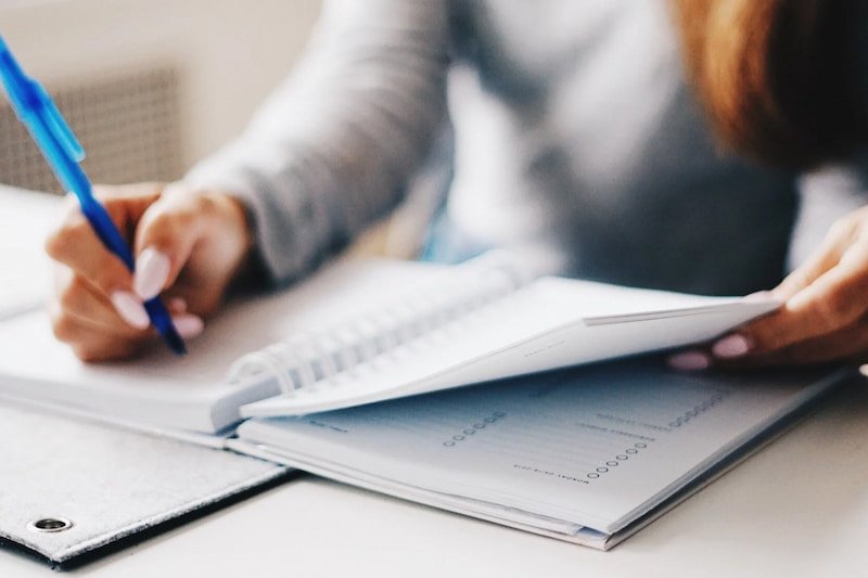 a person writing in a notebook