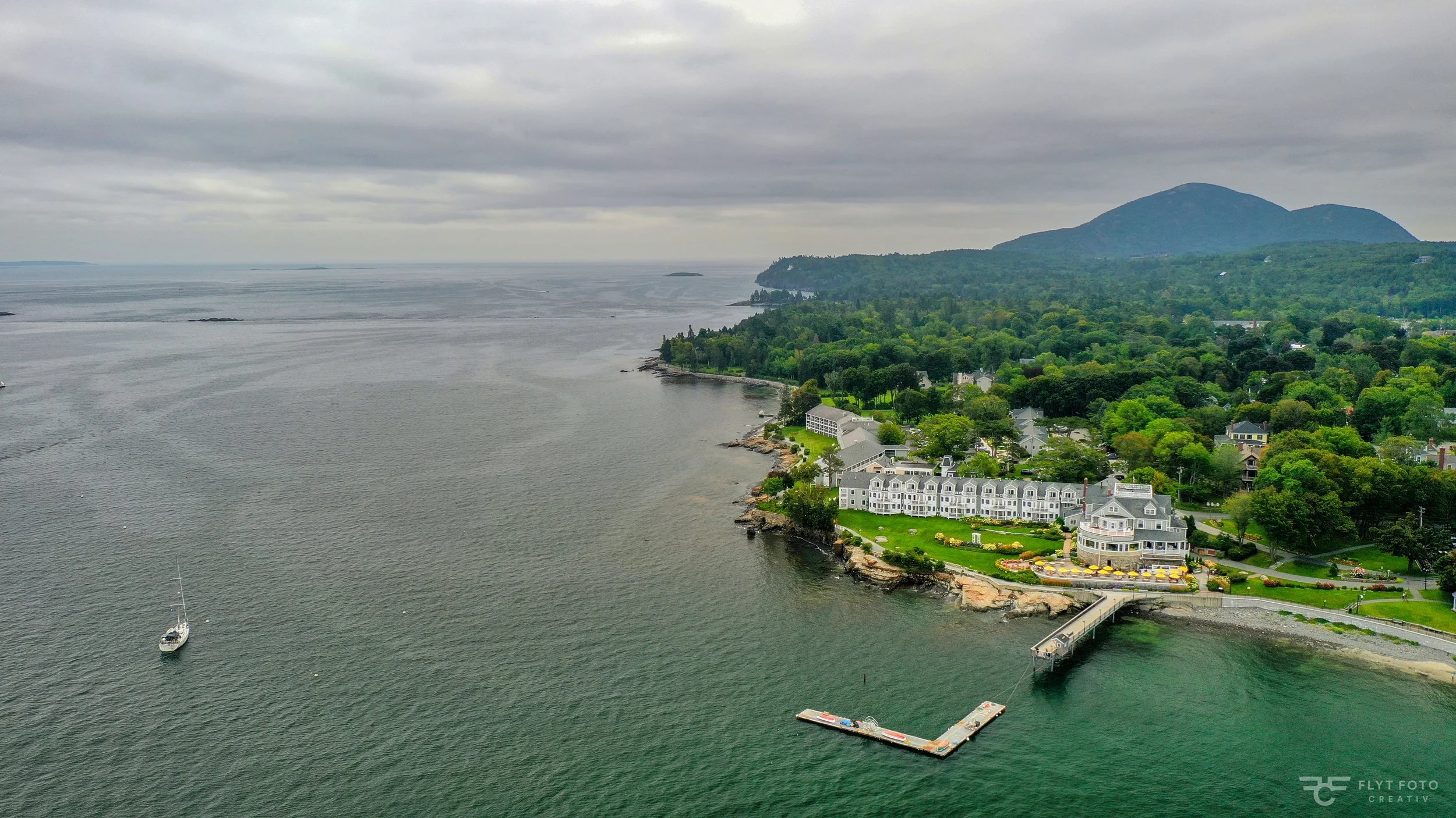 An aerial drone photo of Bar Harbor Inn and Spa and the Atlantic Ocean