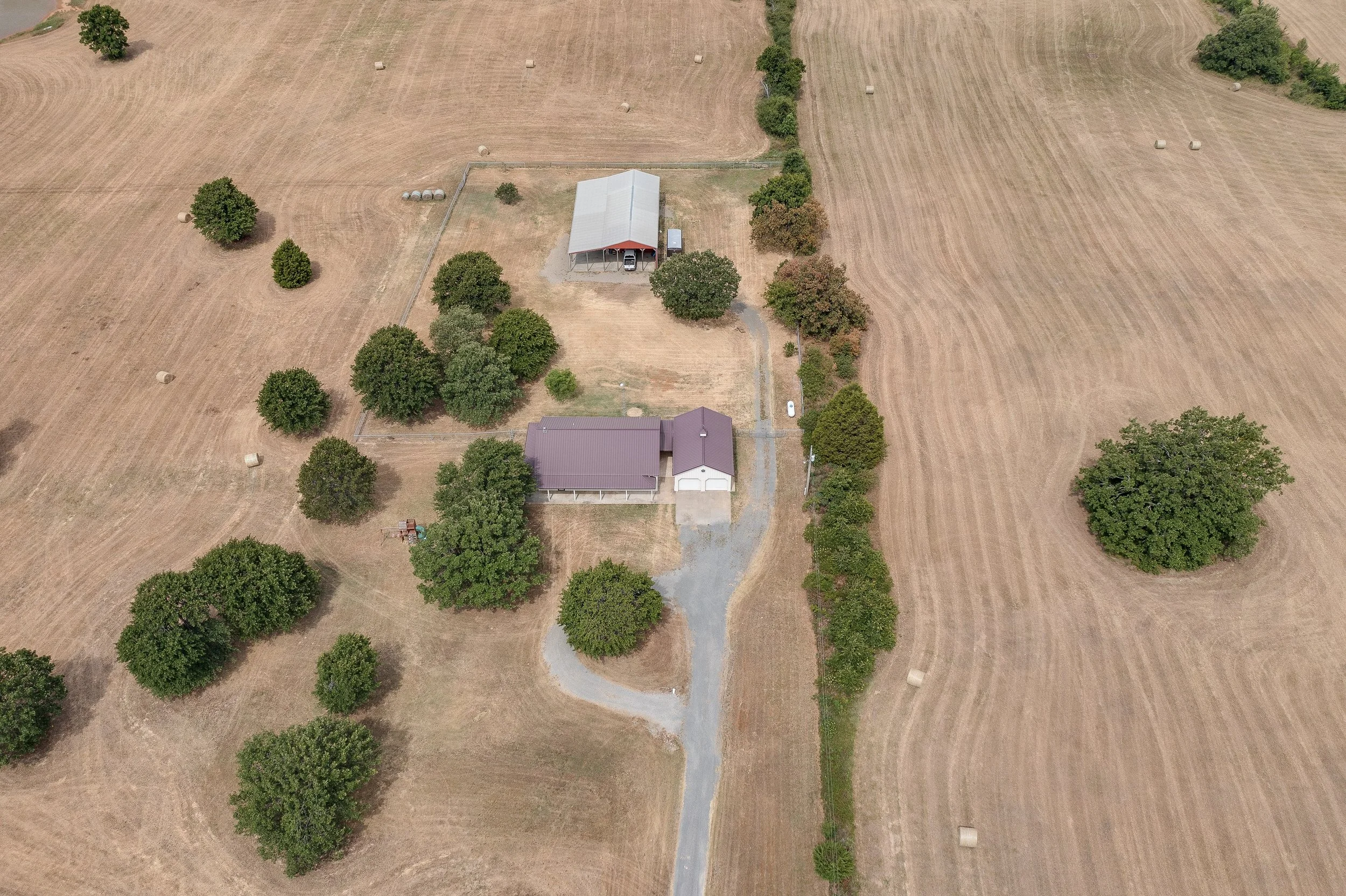 Drone image of a ranch house and large acreage property