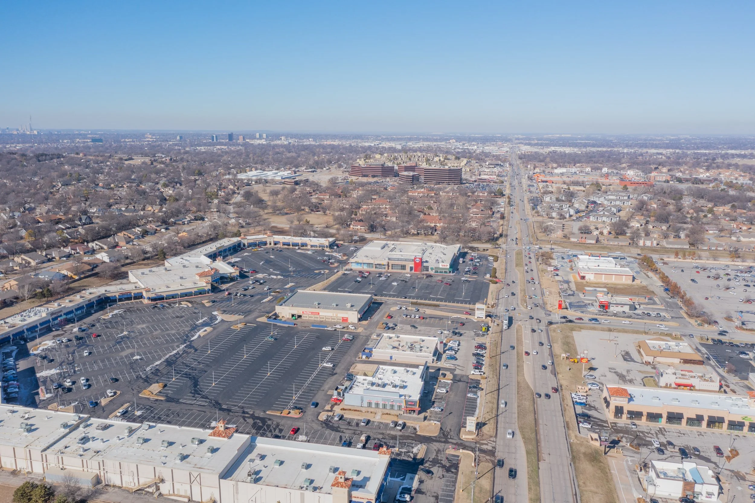Drone image of a shopping center near Woodland Hills Mall in South Tulsa.