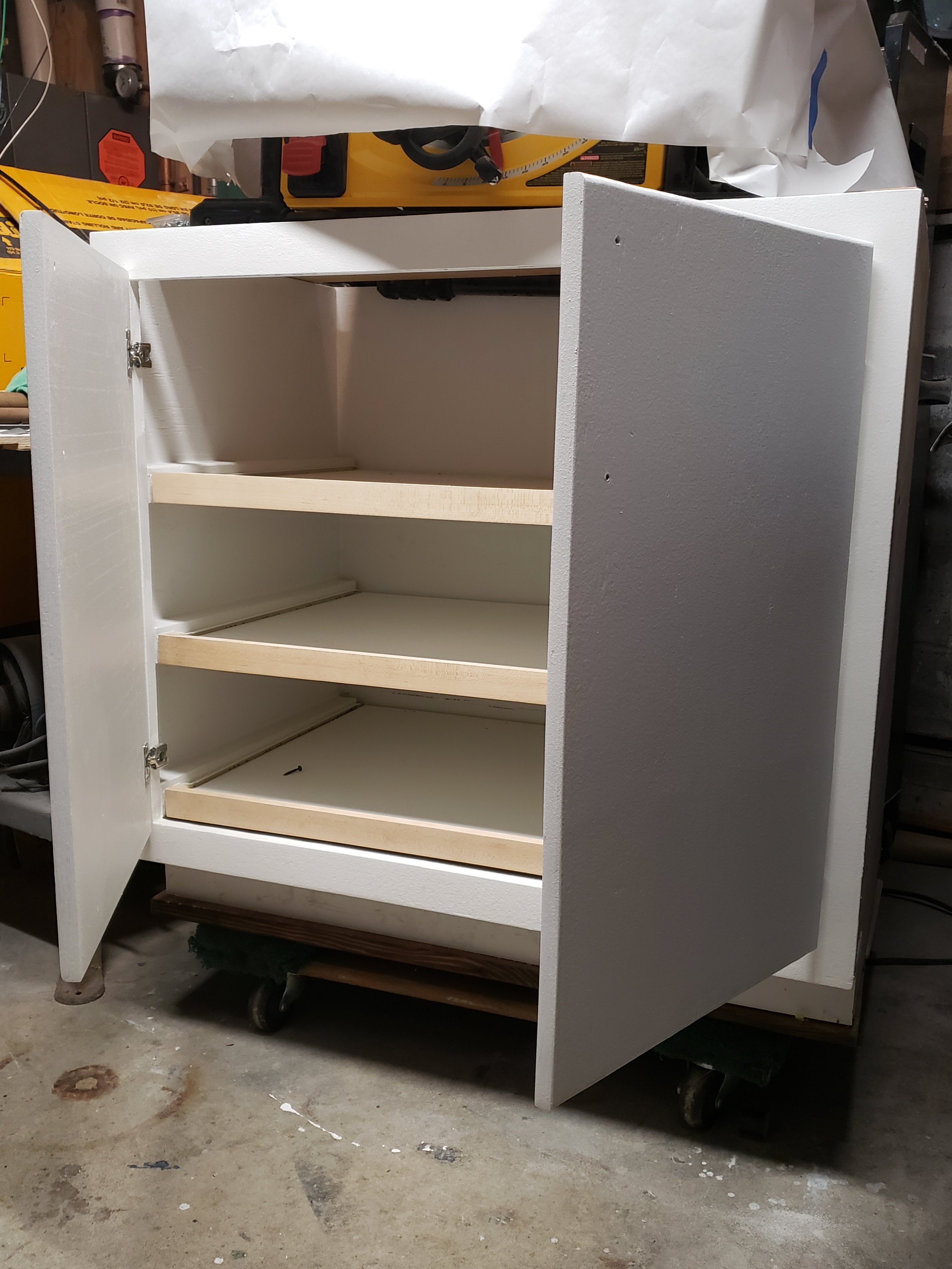 I fabricated a custom lower cabinet with sliding trays, maple drawer fronts, and soft close doors. Up-cycled .75" plywood was used to construct the body of the cabinet, melamine sliding trays for durability and stain resistance, and modernized hinges