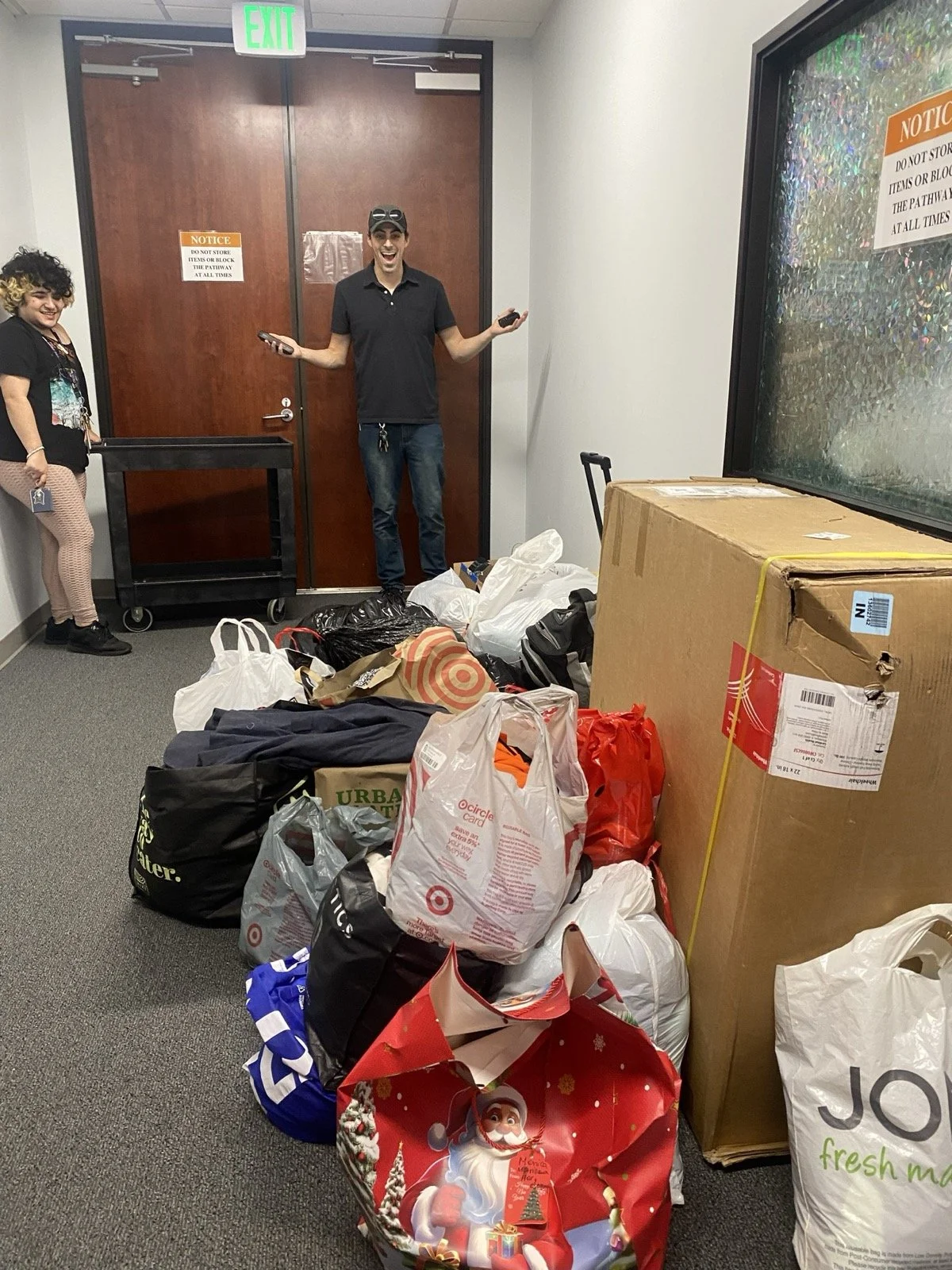 Evan Clark from Atheists United drops off  a large clothing donation in bags for Trans Wellness Center Los Angeles