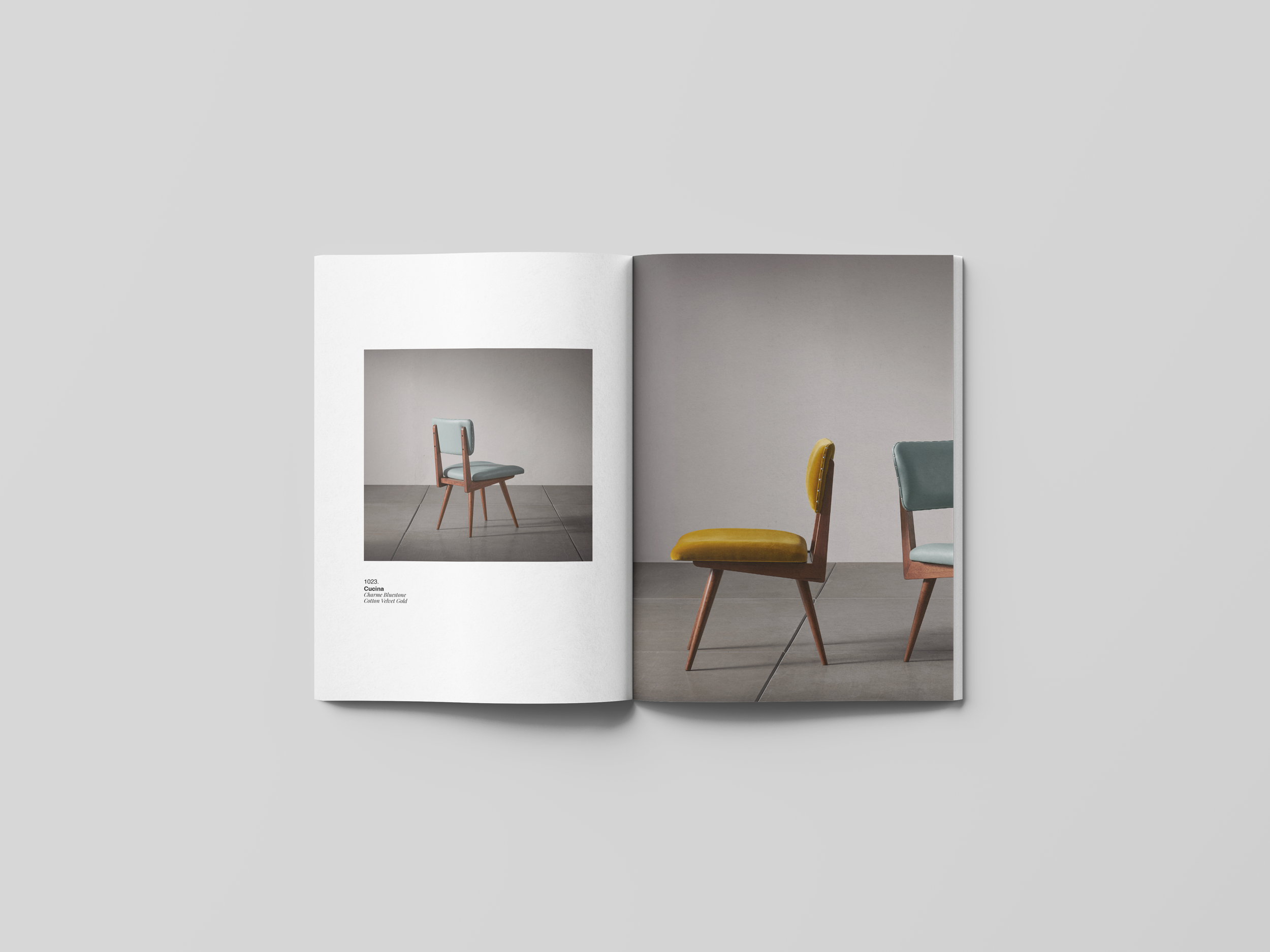 Open magazine featuring two chairs with colorful upholstery in a minimalist setting.