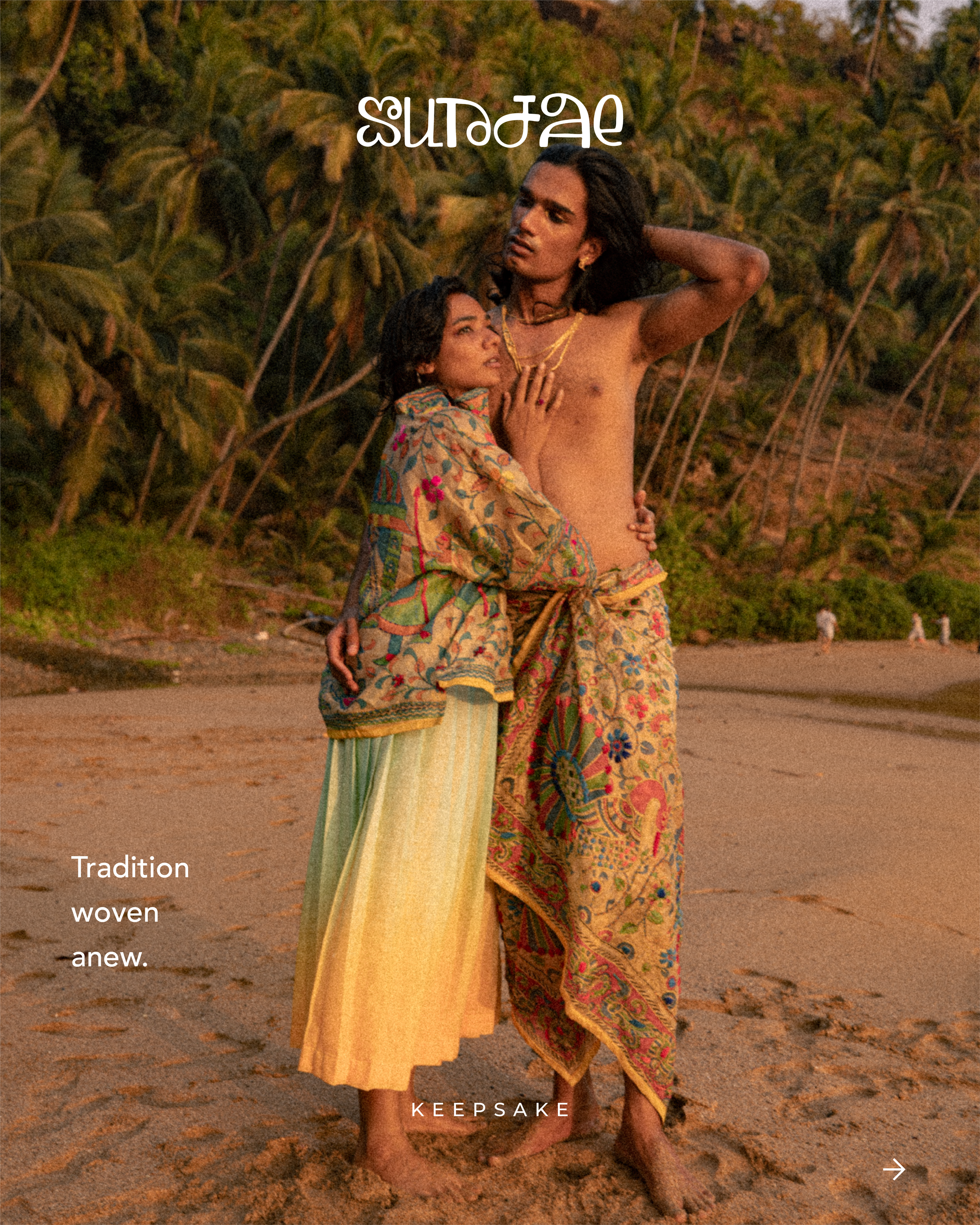 A man and woman dressed in traditional, colorful, embroidered clothing standing on a beach with palm trees in the background. The woman is leaning into the man, who is shirtless and wearing matching patterned wrap. The scene has a warm, earthy tone.