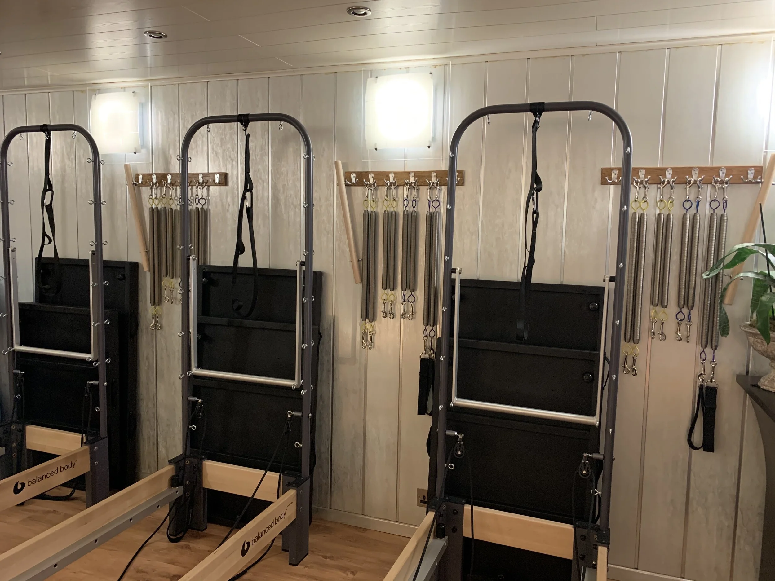 Pilates reformer machines with pilates towers springs and resistance equipment in a physiotherapist-led Pilates studio in Henfield, serving clients from Steyning and Hurstpierpoint in West Sussex.