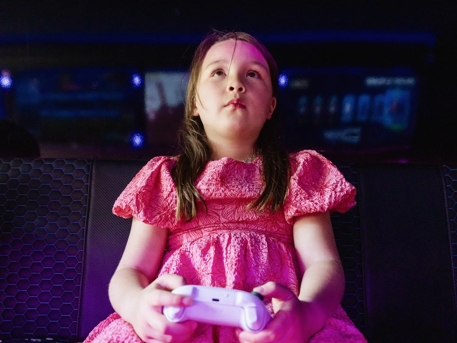 Wide angle shot looking up at a girl gaming in a van