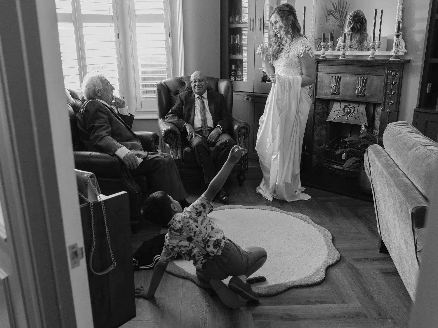 Bride in sitting room with uncles and nephew