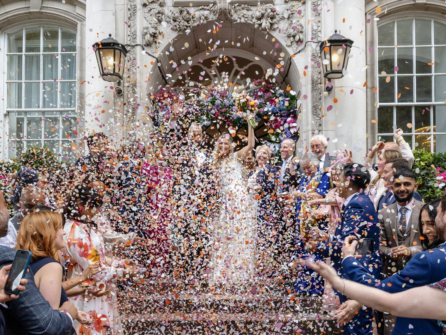 A shower of confetti with the bride and groom barely visible