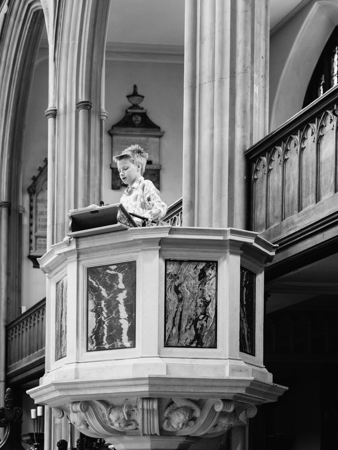 boy in pulpit doing a reading for his brother's christening