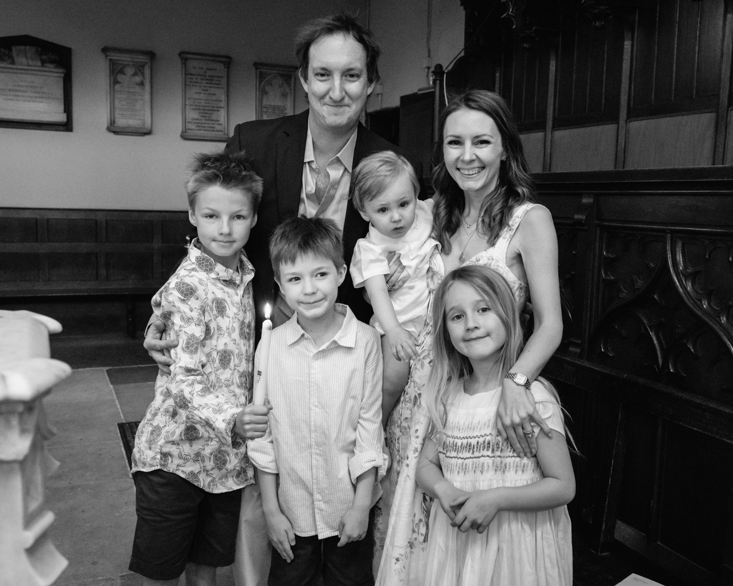 Family portrait with candle at the font.