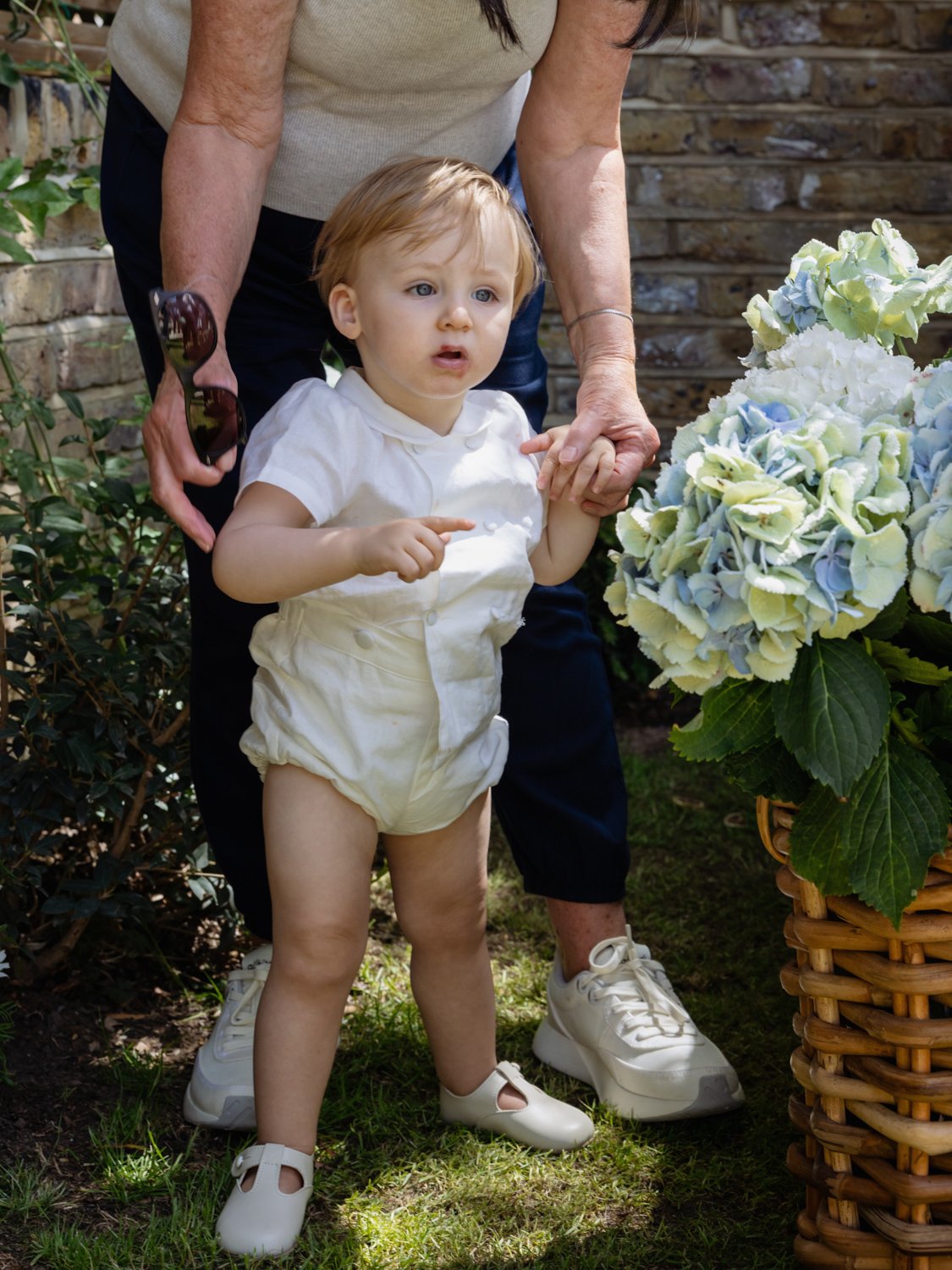Godchild with grandma helping him to stand