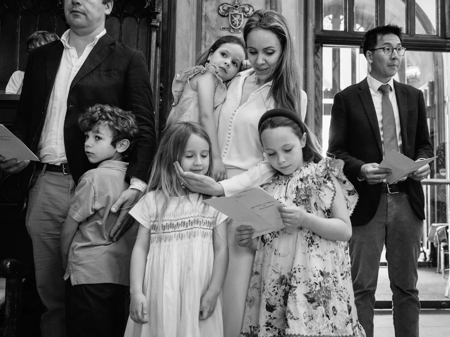Adults and children look on during the hymns after the baptism