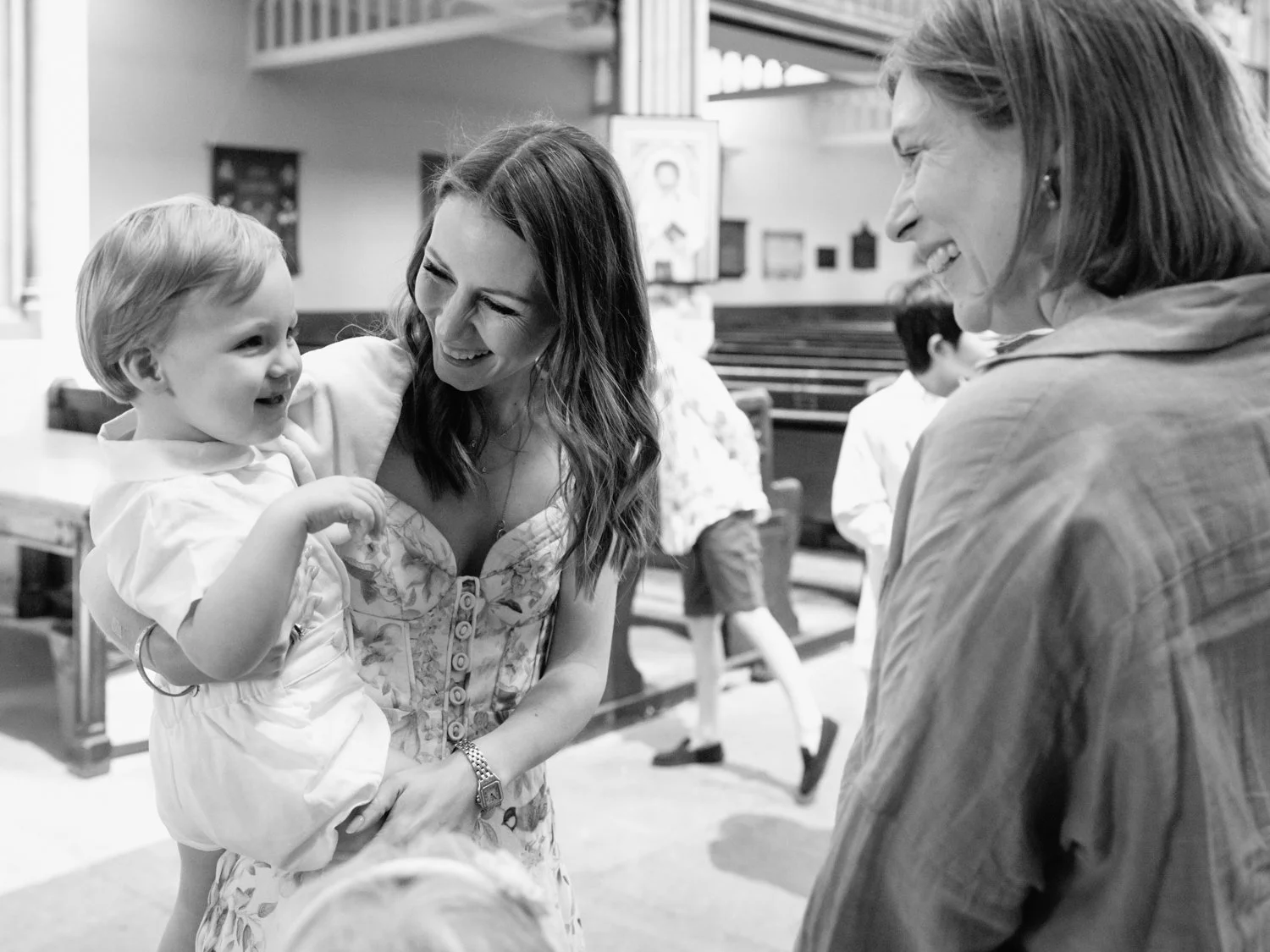 Baby boy smiling at godmother