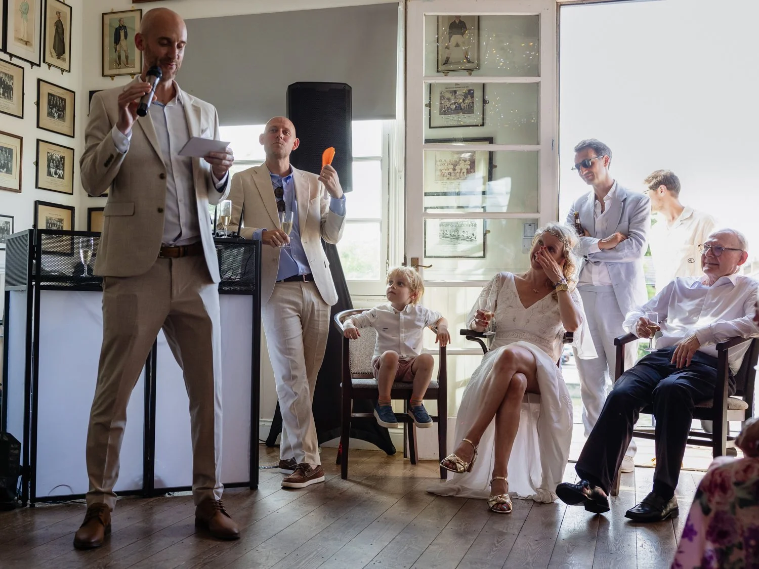 Bride wipes away a tear as the Best Man gives his speech.