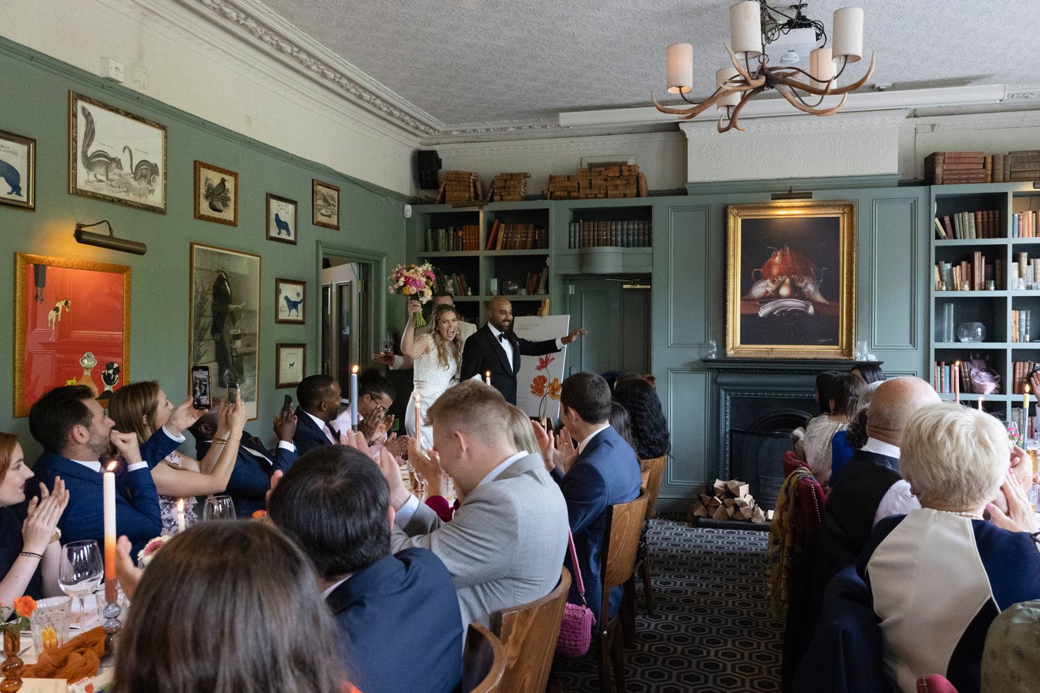 Entrance of bride and groom into the Prince Albert Battersea for their wedding breakfast with guests clapping them in.