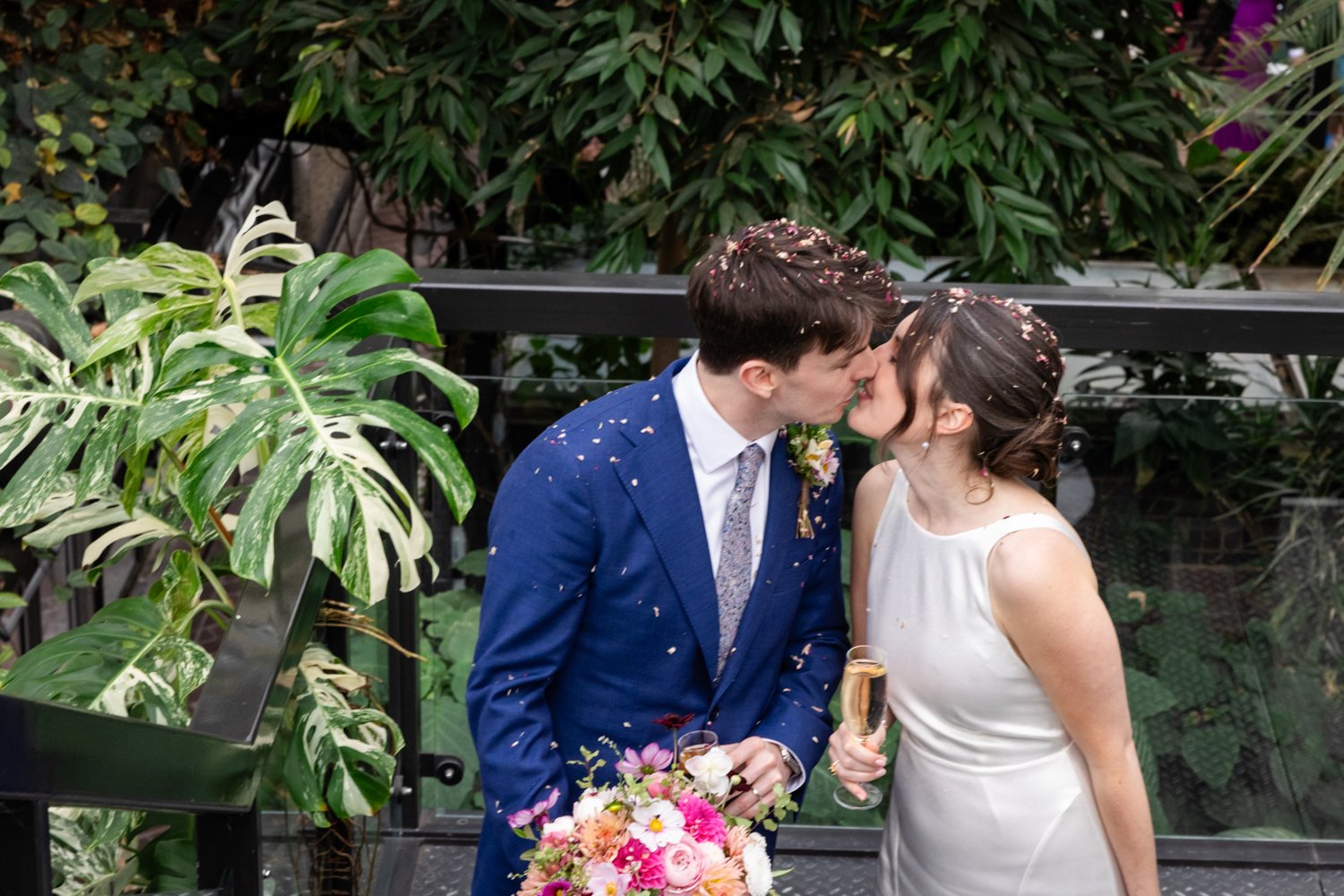Bride and Groom about to kiss with confetti over their heads