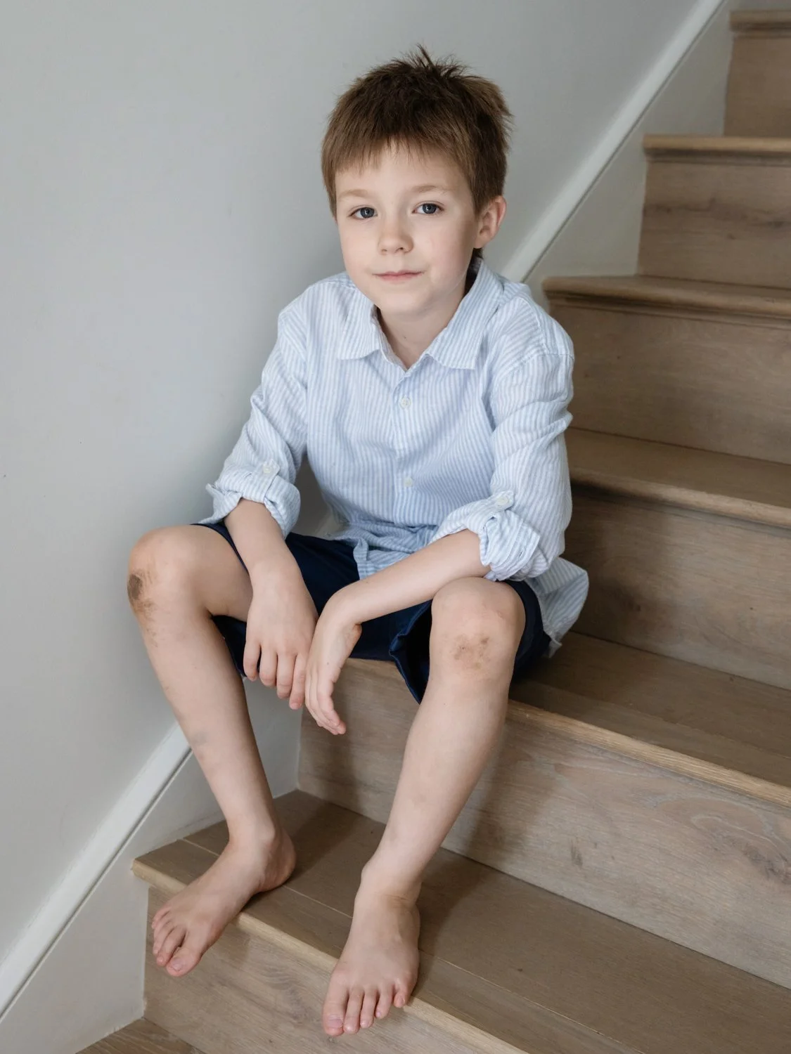 portrait of older son on stairs