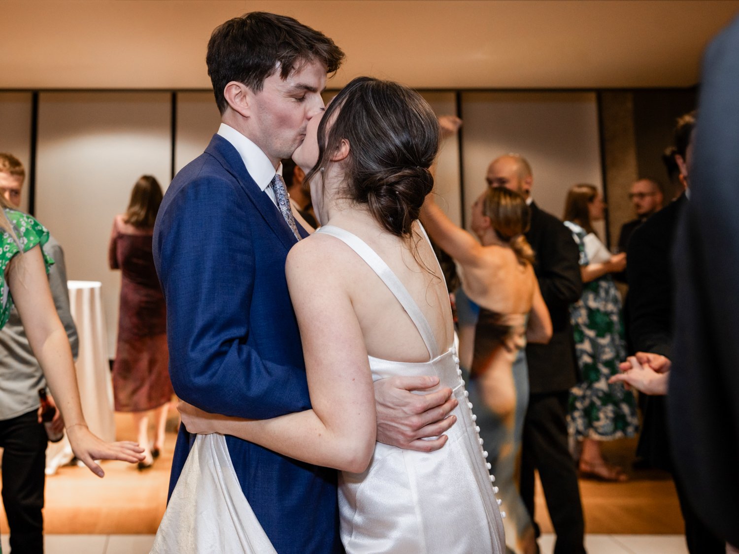 Bride and Groom kissing whilst dancing.