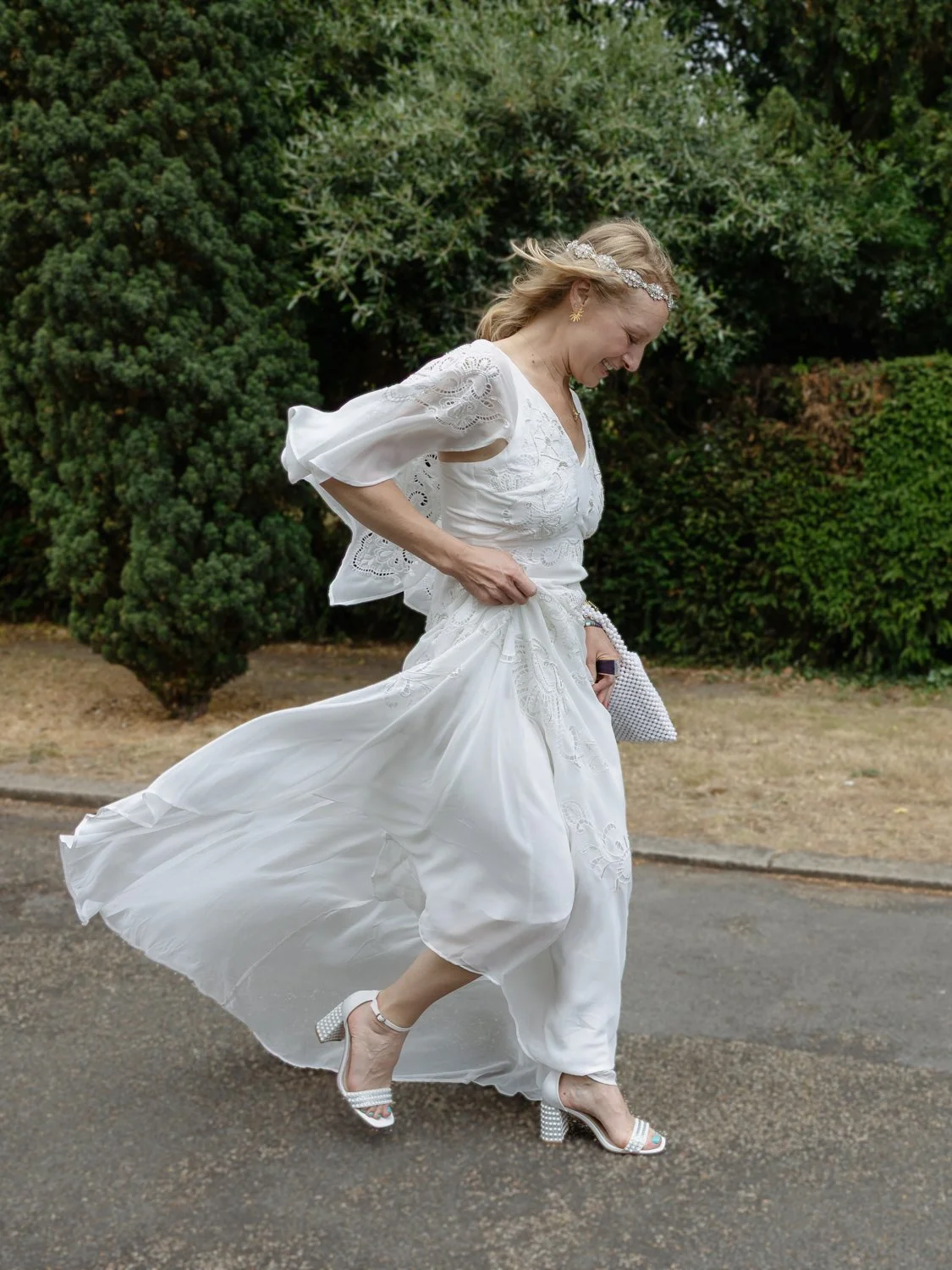 Bride lifting up her skirt as she walks quickly