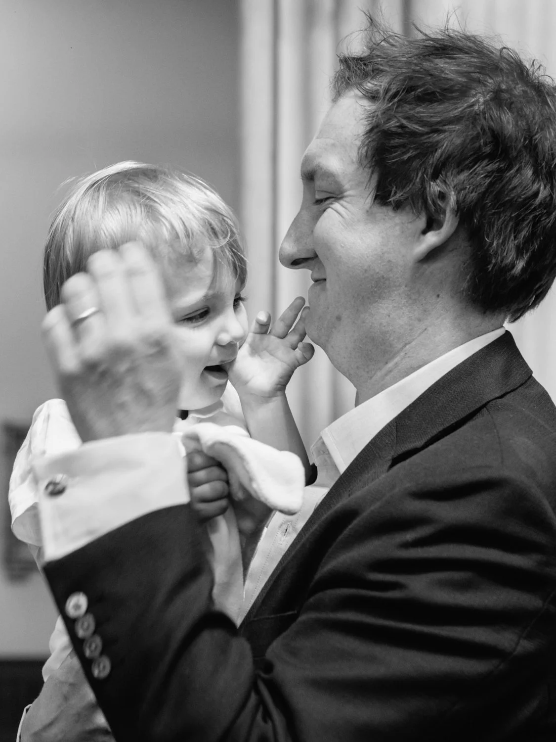 Baby boy laughing with his father