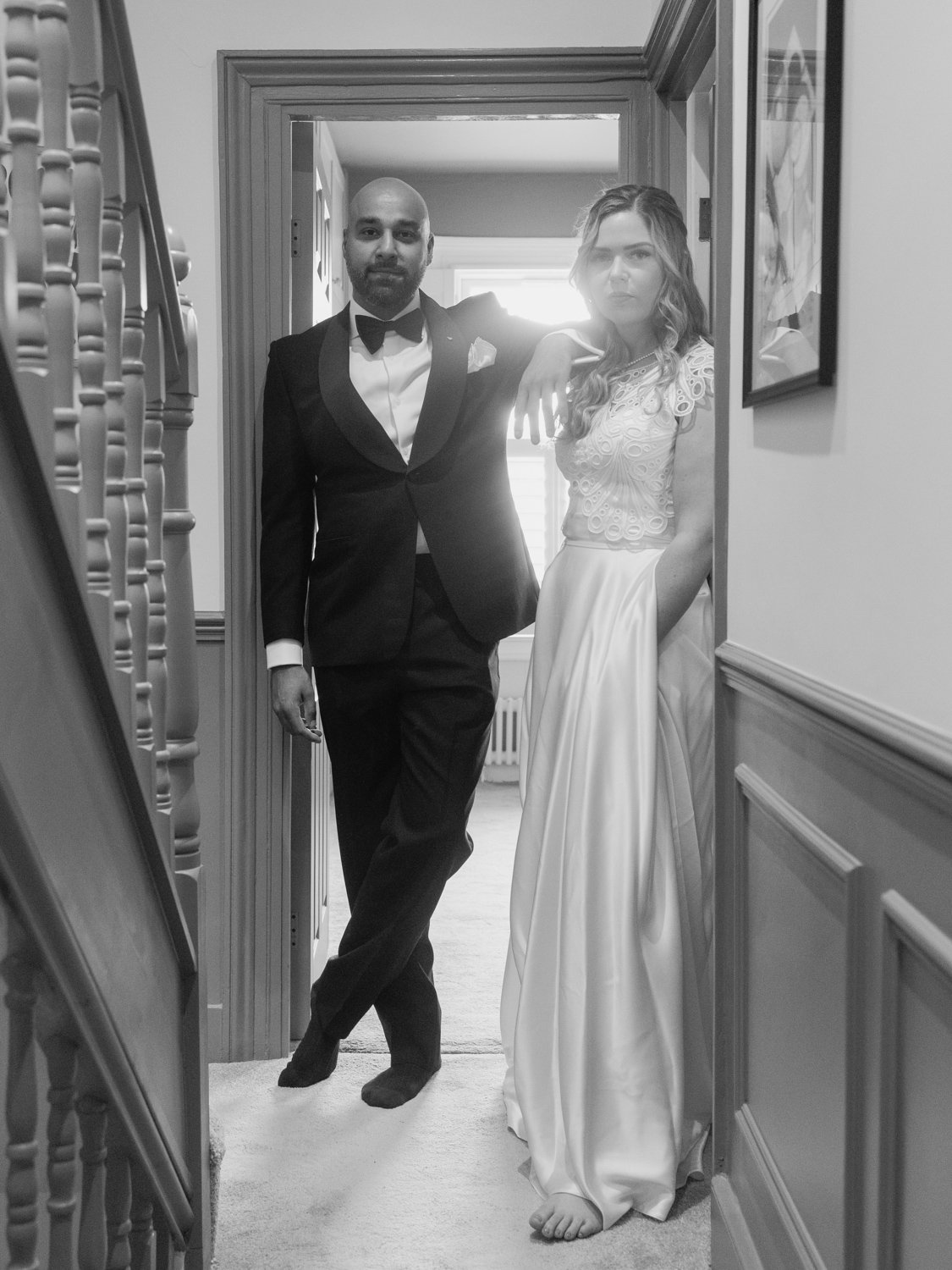 Bride and Groom pose for photo at home on their staircase