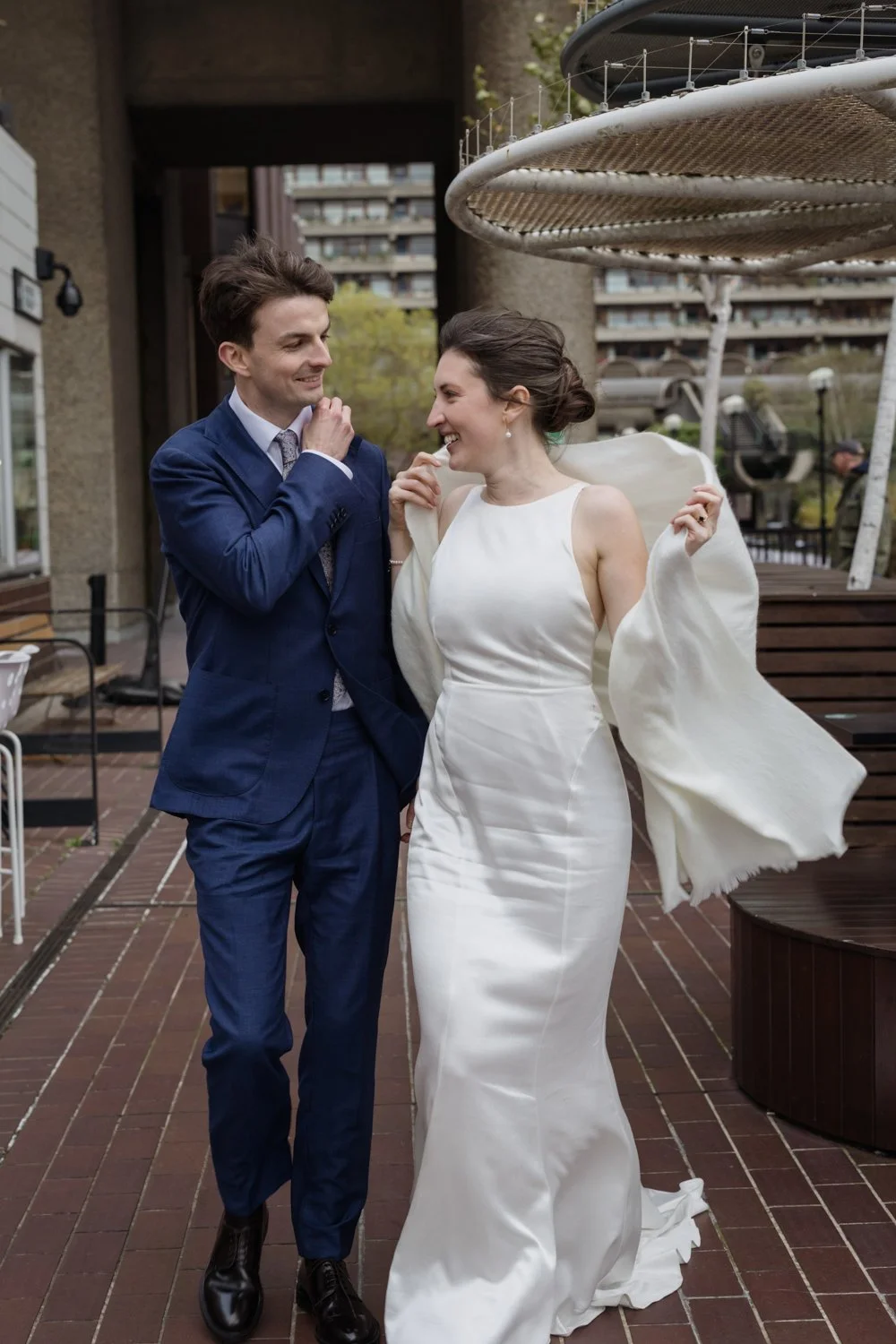 Battling the wind in the Barbican with the bride and groom and her pashmina blowing in the wind.