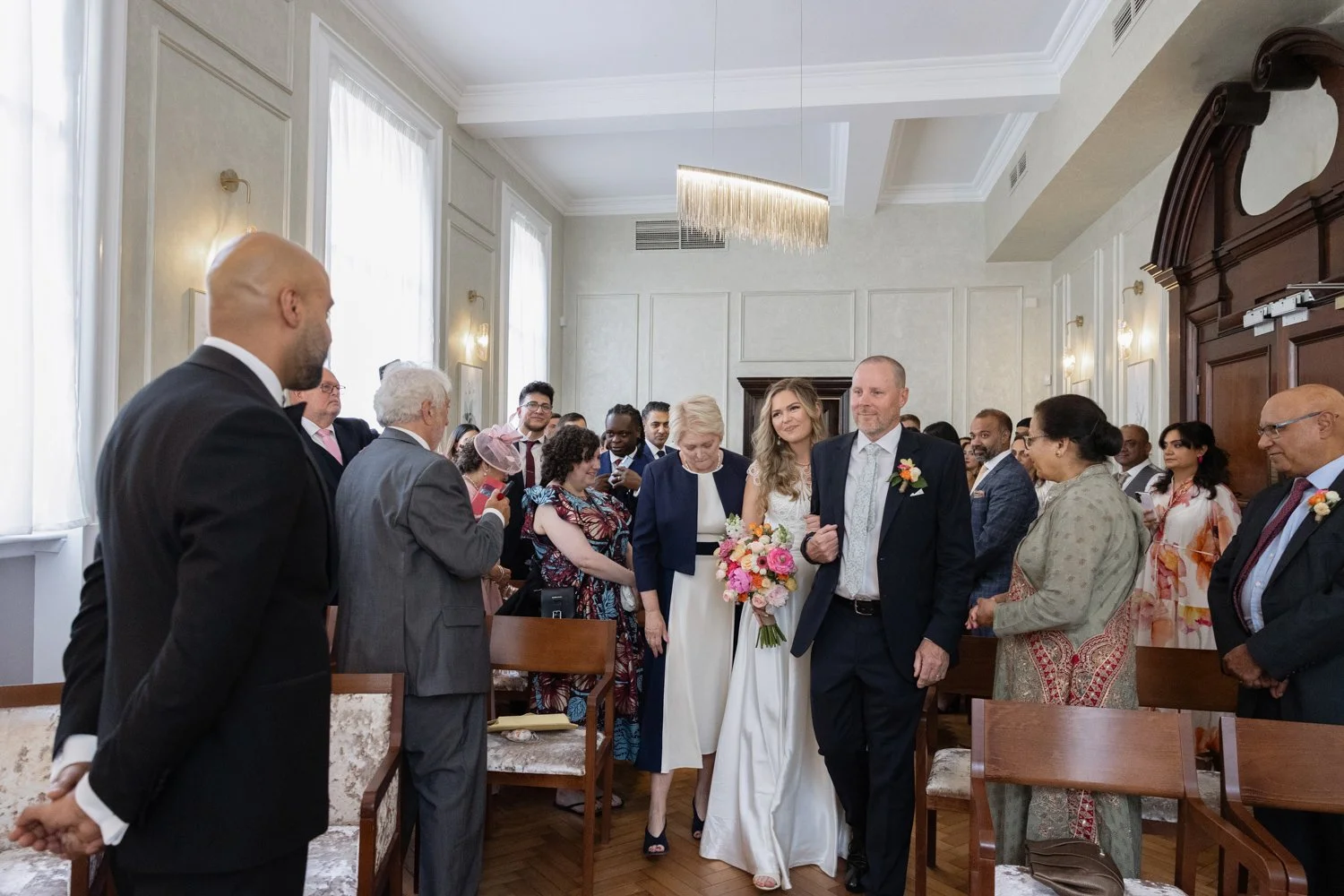 Bride reaches top of the aisle in the Brydon Room at Chelsea Town Hall