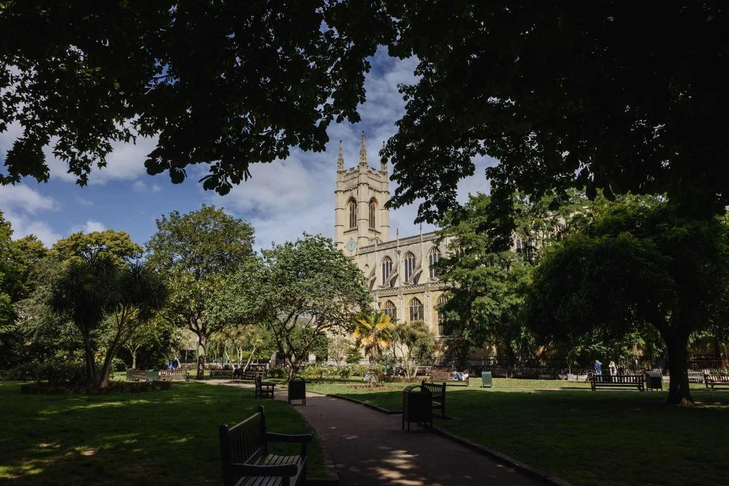 view of st lukes church through the trees of the church yard.