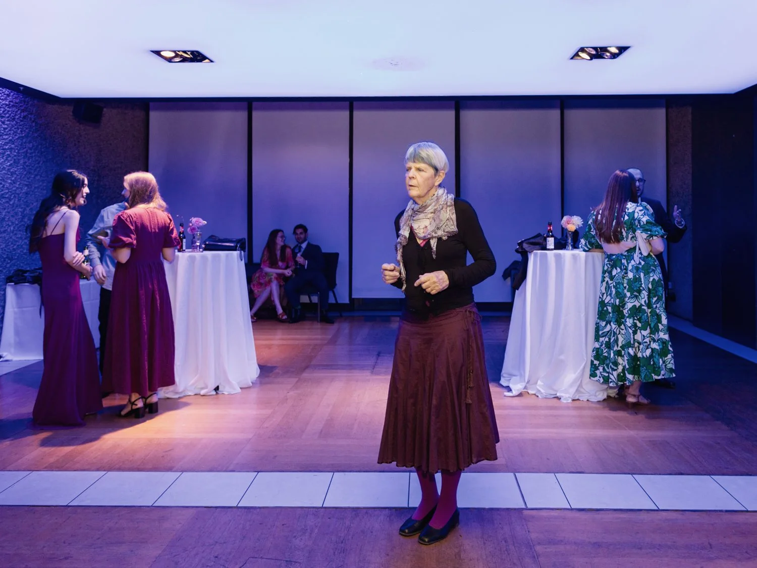 Woman standing on dance floor on her own.