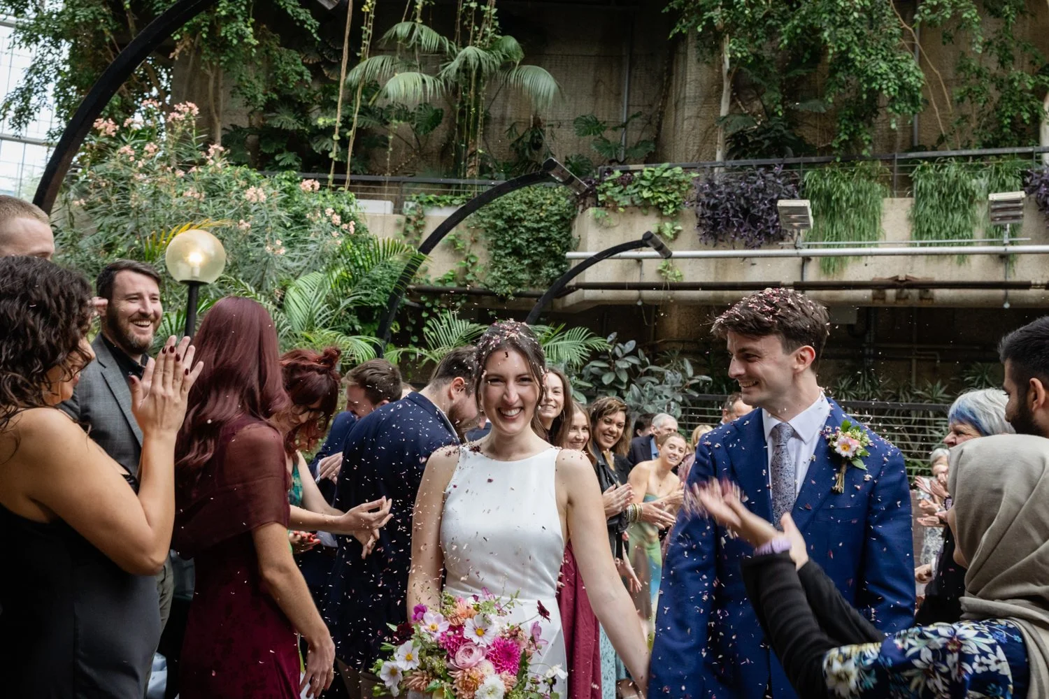 Close up bride and groom with confetti being thrown.