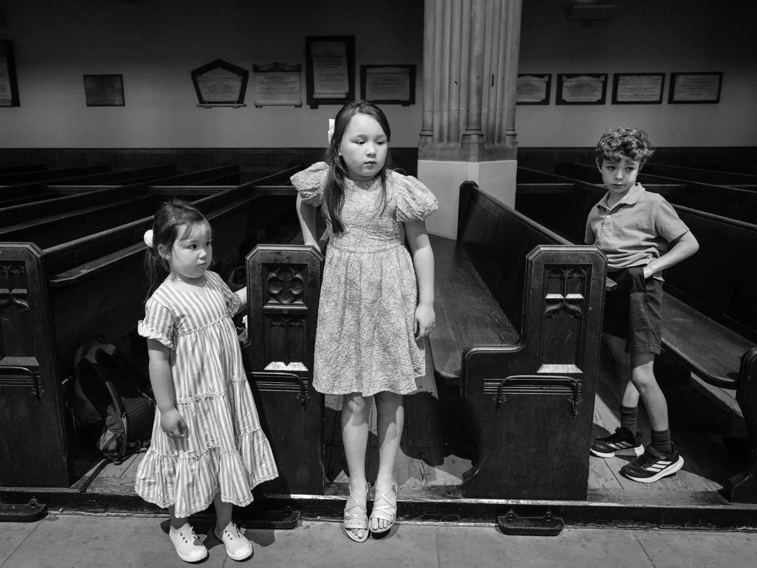 Children waiting patiently in the pews.