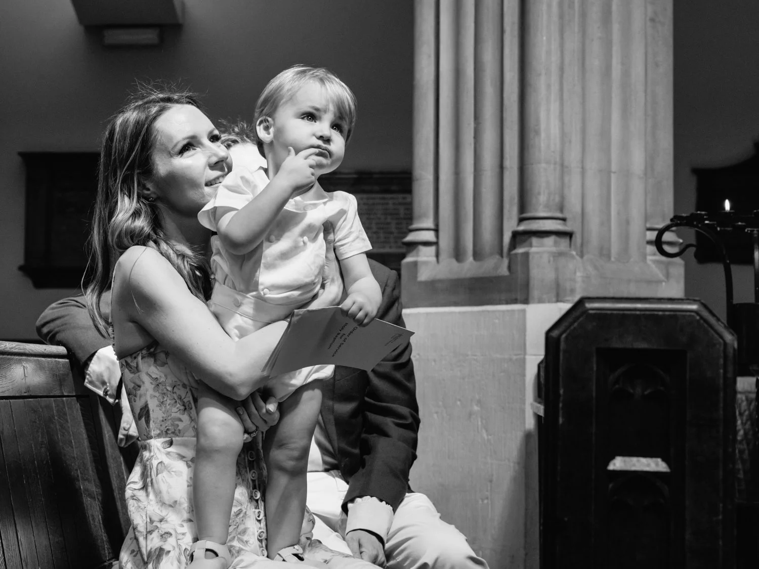 Baby boy watching his siblings do their readings in the pulpit