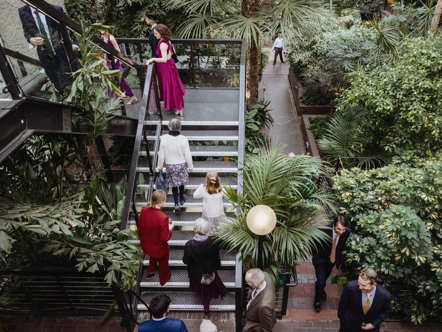 Guests climbing the stairs at the Barbican Conservatory.
