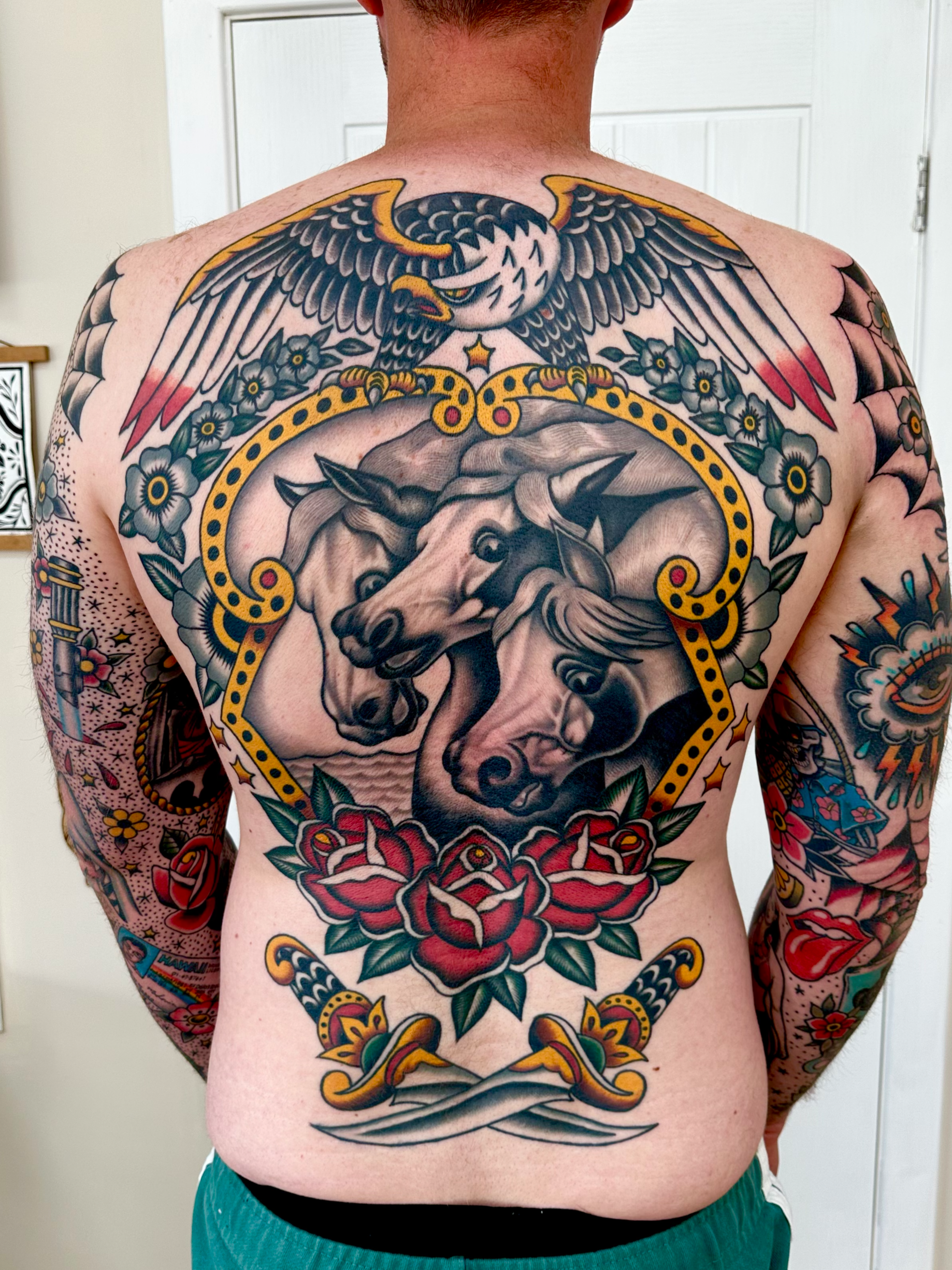 Back piece tattoo with pharaohs horses, and eagle and daggers.
